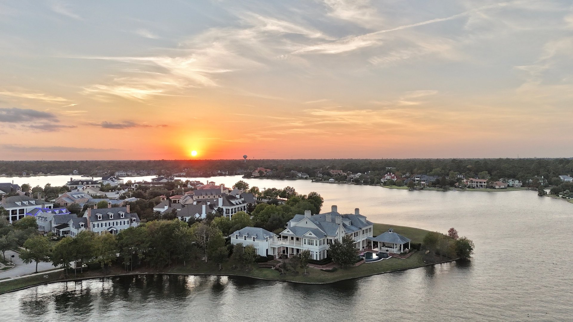 Large mansion houses with swimming pool in affluent neighborhood at sunset